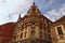 Stunning landscape view of ancient colorful building against cloudy sky. The Rotovz Town Hall Square in Maribor