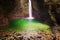 Stunning landscape view of the rocky amphitheatre with a green pool and a white beam of water.