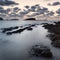 Stunning landscapedawn sunrise with rocky coastline and long exp