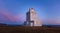 Stunning Lighthouse Dyrholaey in Iceland with an awesome sky and light Sunset