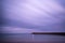 Stunning long exposure landscape lighthouse at sunset with calm