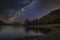Stunning majestic digital composite landscape of Milky Way over Buttermere in Lake District