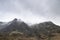 Stunning moody dramatic Winter landscape image of snowcapped Y Garn mountain in Snowdonia