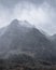 Stunning moody dramatic Winter landscape image of snowcapped Y Garn mountain in Snowdonia with birds flying high above