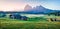 Stunning morning scene of Compaccio village with Langkofel/Sassolungo peak on background. Seiser Alm or Alpe di Siusi location, Bo