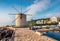 Stunning morning view of old windmill Anemomilos. Sunny summer cityscape of Kerkira tovn, capital of Corfu island, Greece, Europ