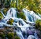 Stunning morning view of pure water waterfall on Plitvice National Park. Colorful spring scene of green forest. Splendid