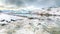 Stunning morning view of Torsfjorden fjord with cracked ice and snowy mountain peaks at background