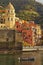 Stunning morning view of Vernazza village. Man on a boat returns from fishing