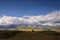 Stunning mountain landscape. Thunderstorm front over the mountain range, sun`s rays shine through fluffy clouds. Beautiful sky.