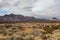 Stunning mountain range rising behind a vast desert vista landscape behind beautiful desert vista