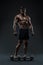 Stunning muscular bodybuilder posing over black background