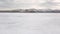 Stunning natural landscape of Siberian wild nature. Clip. Aerial view of an ice boat riding on the ice and snow of Lake