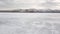 Stunning natural landscape of Siberian wild nature. Clip. Aerial view of an ice boat riding on the ice and snow of Lake