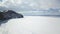 Stunning natural landscape of Siberian wild nature. Clip. Aerial view of ice and snow surface of Lake Baikal in the