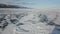 Stunning natural landscape of Siberian wild nature. Clip. Aerial view of ice and snow surface of Lake Baikal in the