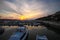 Stunning night view of the setting sun on the sea, boats on the pier