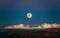 Stunning nightscape featuring an illuminated full moon with Mars on the bottom left