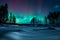 Stunning nightscape featuring a majestic aurora borealis over a snowy forest in British Columbia