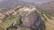Stunning orbit 4k aerial of rock with Catholic cross in Bova, Calabria, Italy