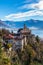 Stunning panorama view of Madonna del Sasso church above Locarno city on cliff with Lake Maggiore, snow covered Swiss Alps