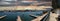 A stunning panoramic shot of the boats and yachts sailing in the harbor with deep blue ocean water and powerful clouds