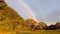 Stunning perfect double rainbow arch over paddocks in Australia