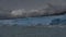 The stunning Perito Moreno glacier against a cloudy sky and mountains.