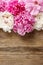 Stunning pink peonies on rustic wooden background