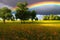 Stunning rainbow in stormy skies over the meadow