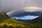 Stunning rainbow in stormy skies over the mountains