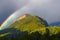 Stunning rainbow in stormy skies over the mountains