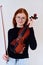 Stunning Redhead Musician Poses with Violin in Captivating Portrait
