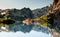 Stunning reflection of Andes mountains and Refugio Italia Manfredo Segre in Laguna Negra lake in Patagonia, Argentina. Winter back