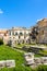 Stunning ruins of the Temple of Apollo in Ortigia Island, Syracuse, Sicily, Italy captured on a vertical photo with blue sky.