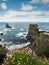 Stunning scene with cliffs, rough stone island, ocean and blue cloudy sky. Ireland, Kilkee area. Travel, tourism and sightseeing