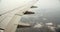 Stunning shot of an airplane wing flying over the clouds and some birds