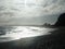 Stunning shot of coastline with sunlit waves under a cloudy sky