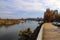 A stunning shot of the Cumberland river with gorgeous autumn trees along the banks with a view of the skyscrapers