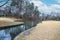 A stunning shot of the pond and the lush green and autumn colored trees and lush brown ground cover at Duck Pond Park