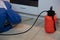 Stunning shot of a professional exterminator spraying a chemical under a kitchen counter