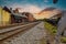 A stunning shot of the railroad tracks covered in gravel with lush green grass on the edges