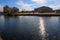 A stunning shot of the still blue lake water surrounded by gorgeous autumn trees in the park with a view of The Parthenon