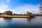 A stunning shot of the still blue lake water surrounded by gorgeous autumn trees in the park with a view of The Parthenon