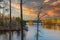 A stunning shot of the still blue waters of the lake at Stone Mountain park with lush green and autumn colored trees reflecting of