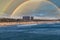 A stunning shot of vast blue ocean water and the cityscape along the beach with brown sand, hotels and buildings