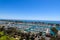 A stunning shot of the vast blue ocean water with white boats and yachts docked in the harbor and sailing in the harbor