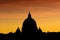 Stunning silhouette view of the dome of basilica San Pietro in Rome at red sunset, backlight