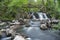 Stunning Slow falling Water Hallamolla Waterfall in lush rural Forest during springtime