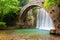 Stunning spring landscape.Paleokarya, old stone arched bridge, between two waterfalls.